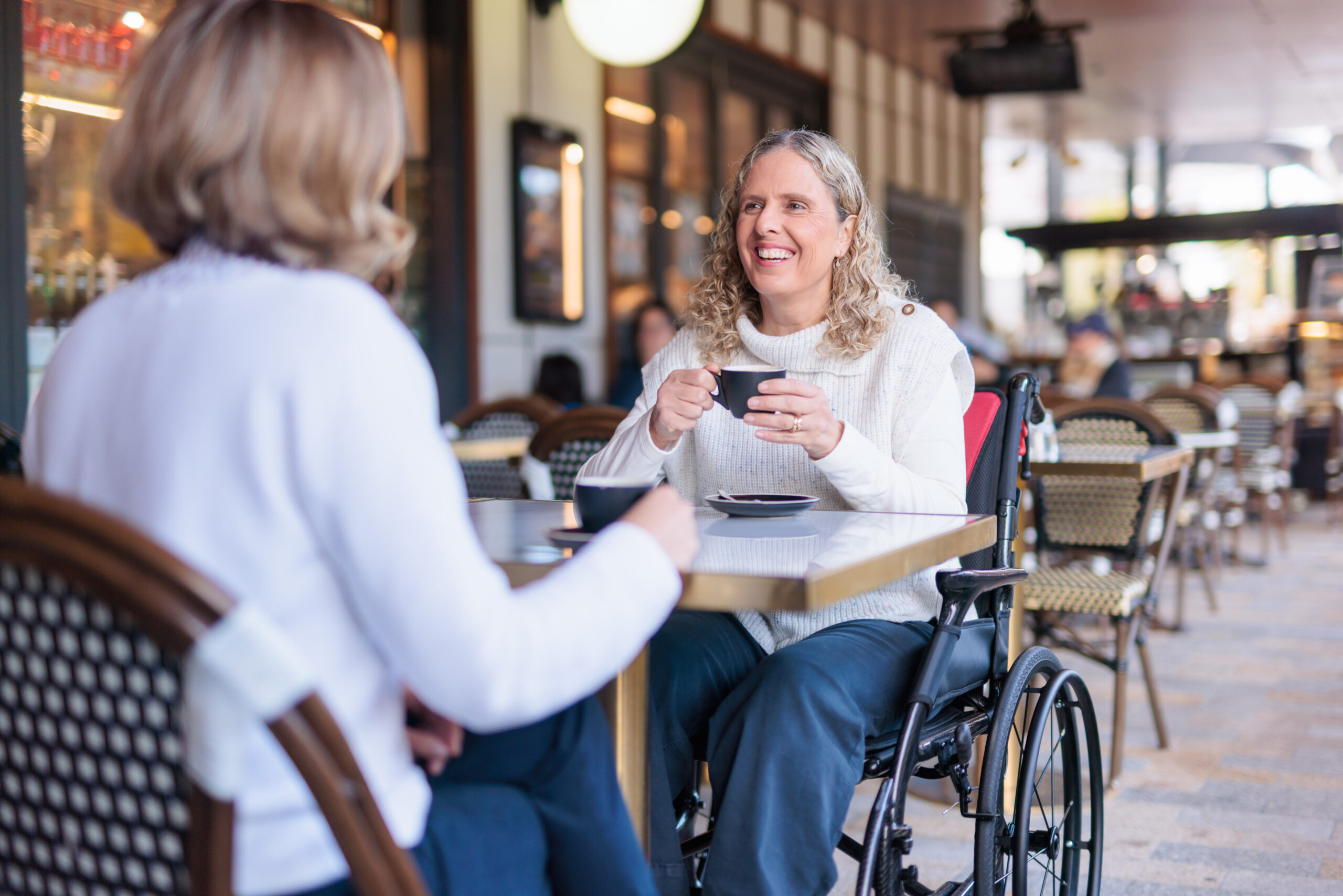 An ILS specialist helping a customer adjust a rollator in a showroom